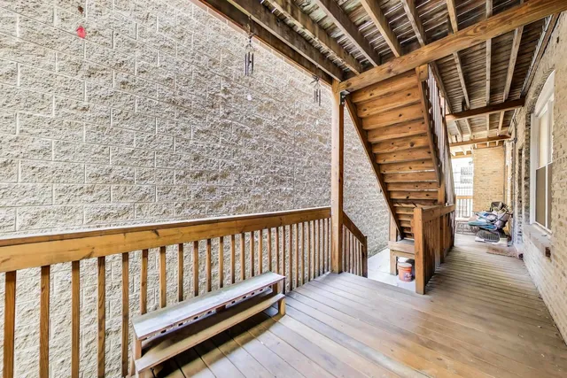 a view of balcony with wooden floor and fence
