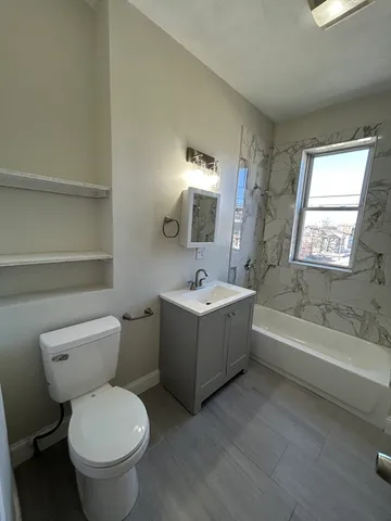 a bathroom with a sink a toilet and bathtub