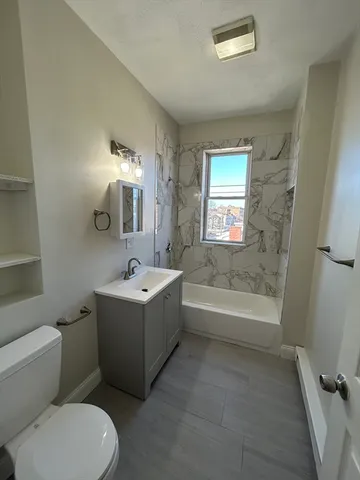 a bathroom with a bathtub toilet and sink