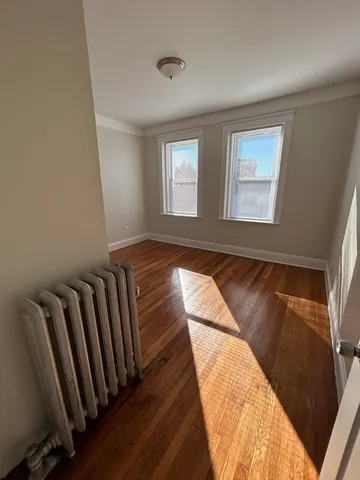 a view of a room with wooden floor and windows