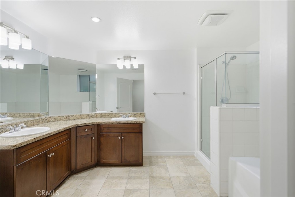 629 Traction Avenue, Unit 257 Los Angeles, CA 90013 - Photo 15 of 38 a spacious bathroom with a granite countertop sink a mirror and a