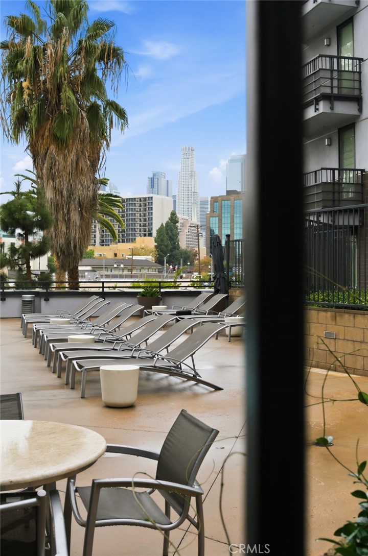 629 Traction Avenue, Unit 257 Los Angeles, CA 90013 - Photo 27 of 38 a view of a patio with table and chairs and potted plants
