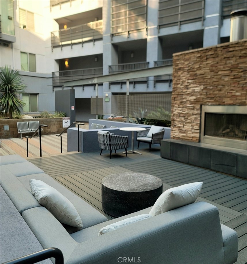 629 Traction Avenue, Unit 257 Los Angeles, CA 90013 - Photo 31 of 38 a view of a patio with couches table and chairs with potted plants
