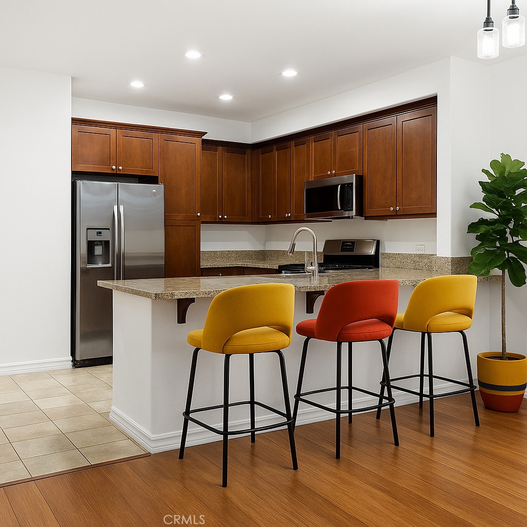 629 Traction Avenue, Unit 257 Los Angeles, CA 90013 - Photo 7 of 38 a kitchen with stainless steel appliances granite countertop a stove a sink a microwave a dining table and chairs with wooden floor