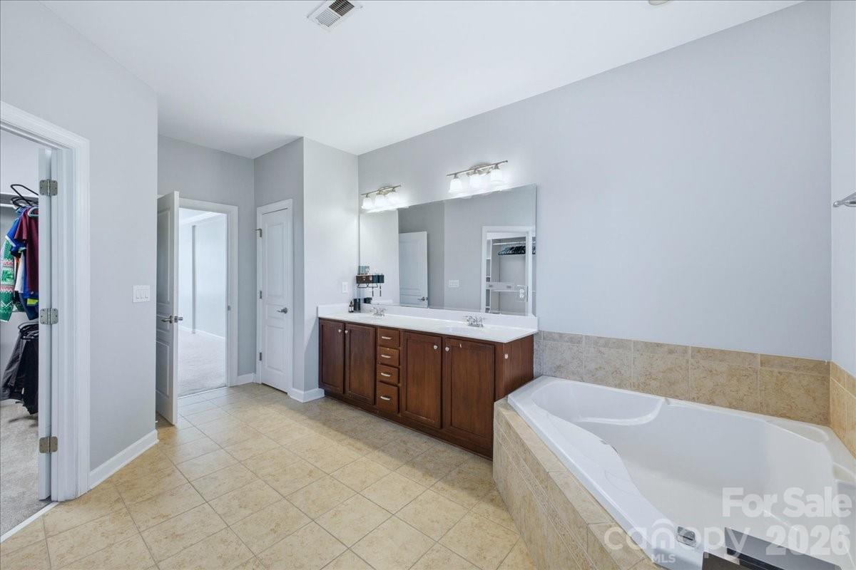 1825 Laveta Road Charlotte, NC 28269 - Photo 21 of 48 a spacious bathroom with a tub sink and mirror