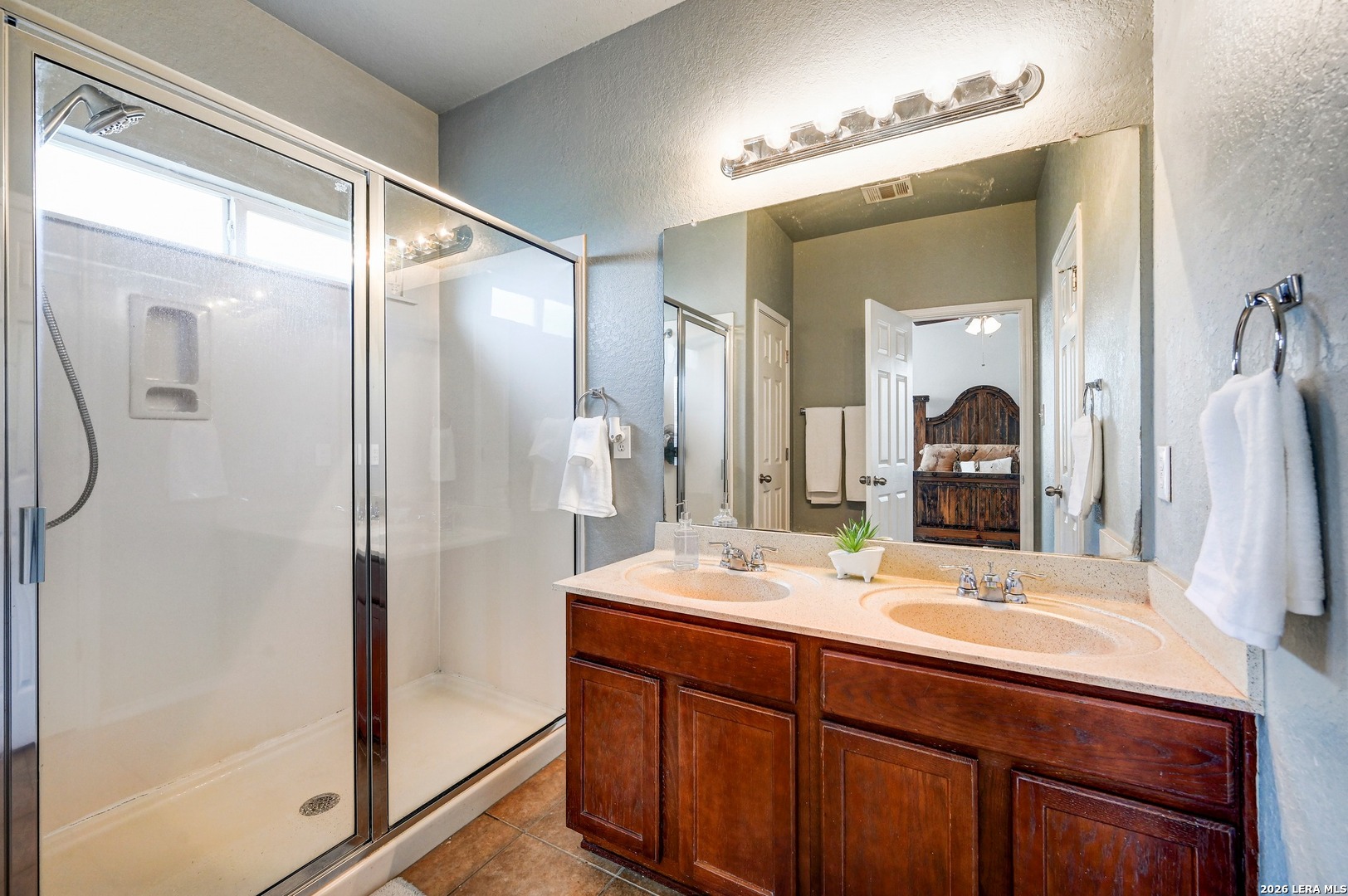 720 Hollow Ridge Schertz, TX 78108 - Photo 17 of 27 a bathroom with a double vanity sink and a mirror