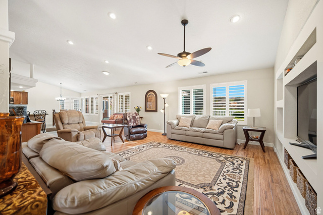 1985 West Rivers Edge Lane St. George, UT 84770 - Photo 13 of 42 Living area featuring light wood-type flooring, ceiling fan, vaulted ceiling, and a chandelier