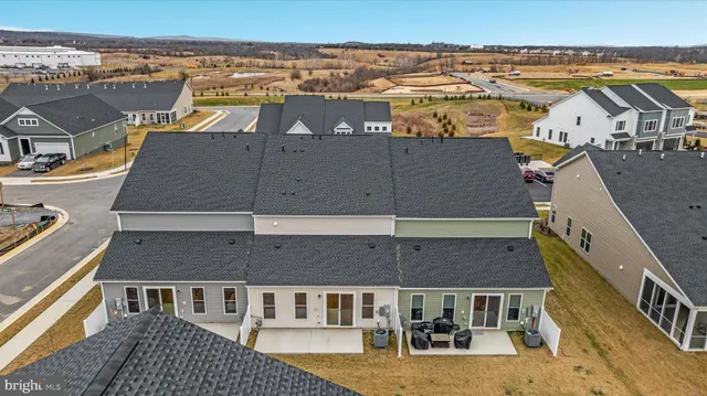 an aerial view of residential houses with outdoor space