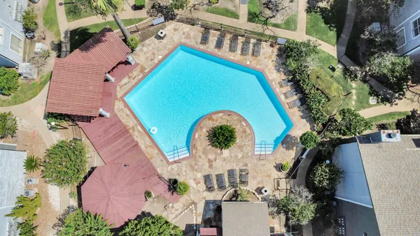 an aerial view of a house with a swimming pool