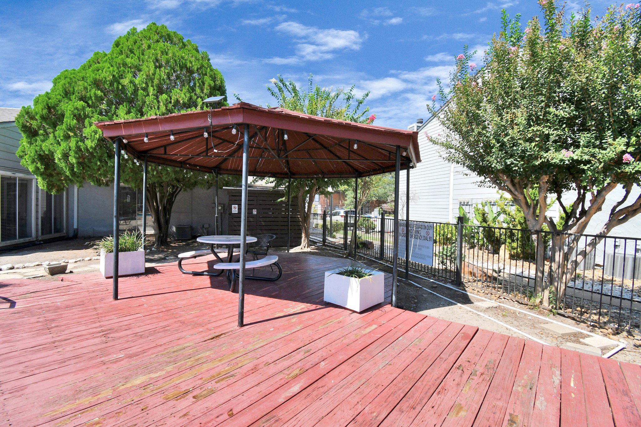 5959 Bonhomme Road, Unit 329R Houston, TX 77036 - Photo 10 of 24 a view of a patio with a table and chairs under an umbrella with wooden floor