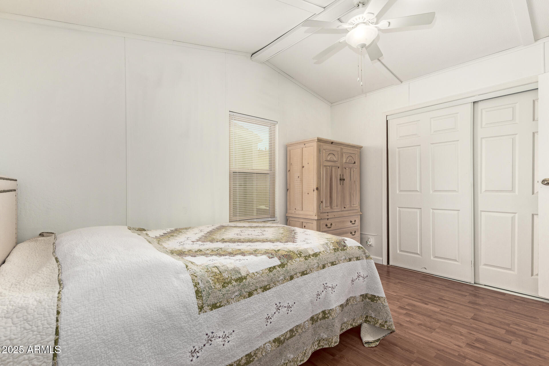 5735 East McDowell Road, Unit 213 Mesa, AZ 85215 - Photo 12 of 18 a bedroom with a bed and a chandelier