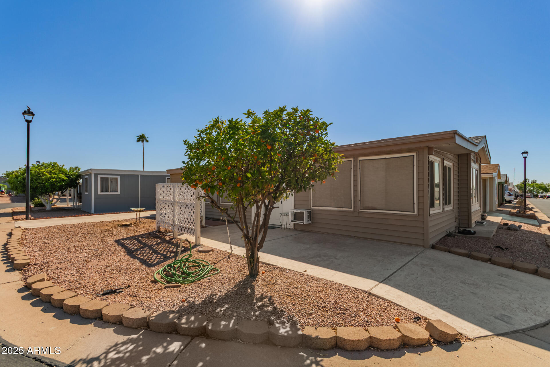 5735 East McDowell Road, Unit 213 Mesa, AZ 85215 - Photo 3 of 18 a front view of a house with a yard