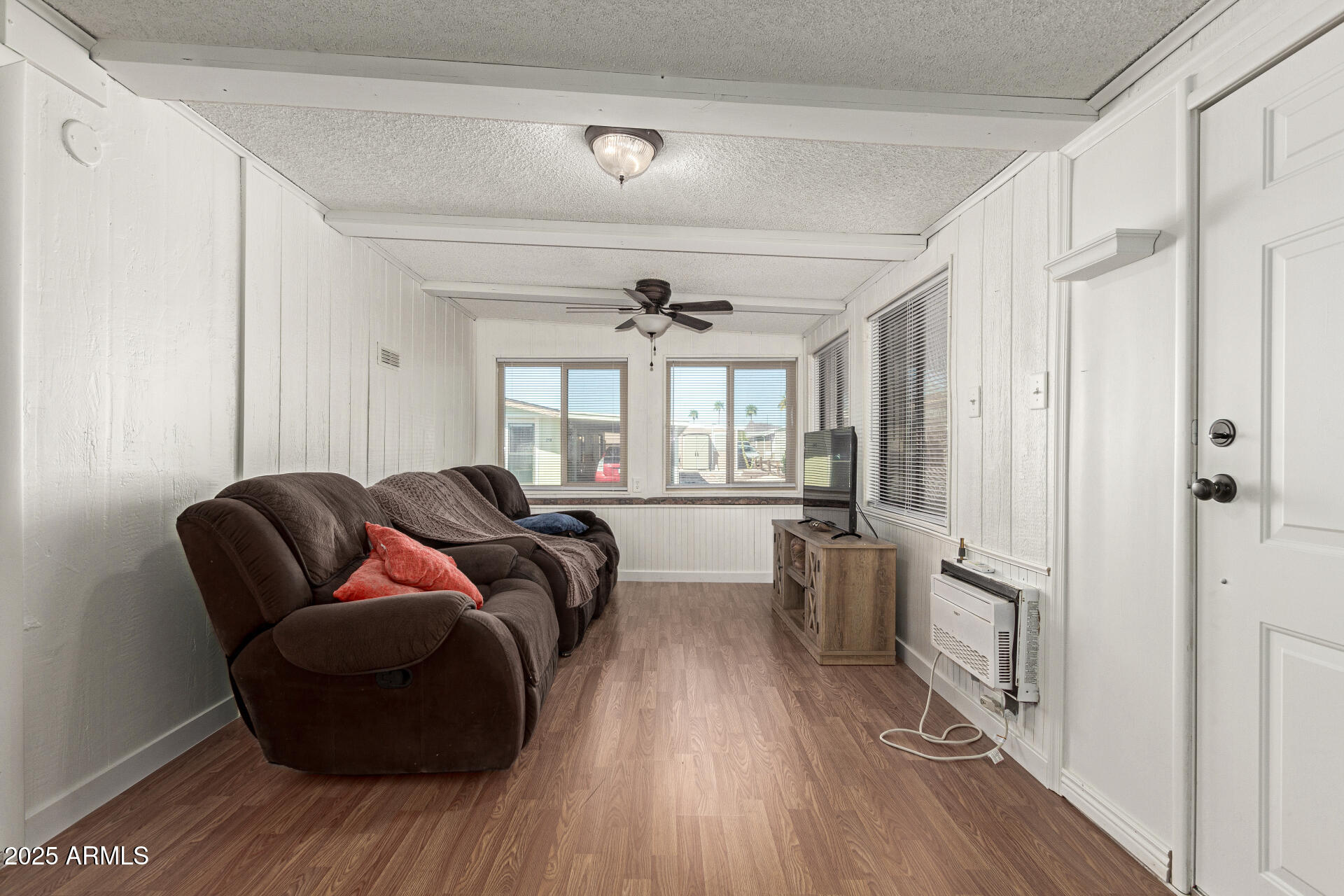 5735 East McDowell Road, Unit 213 Mesa, AZ 85215 - Photo 4 of 18 a living room with furniture and a wooden floor