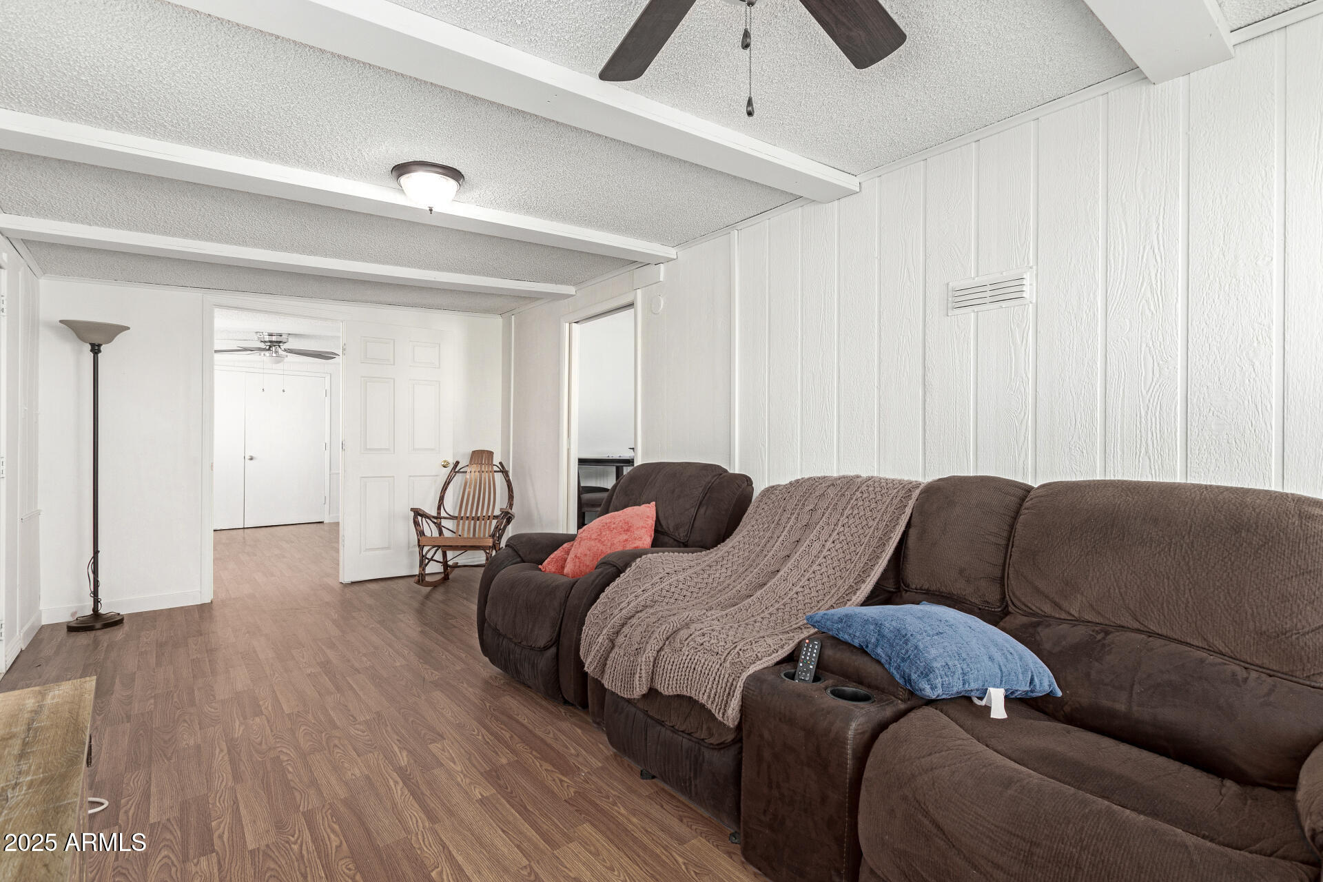 5735 East McDowell Road, Unit 213 Mesa, AZ 85215 - Photo 5 of 18 a bedroom with a bed and a couch