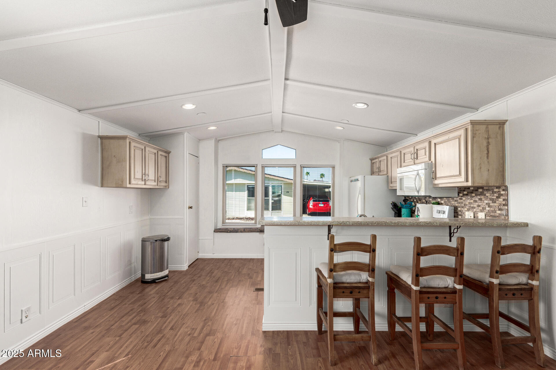 5735 East McDowell Road, Unit 213 Mesa, AZ 85215 - Photo 6 of 18 a kitchen with stainless steel appliances a dining table chairs stove and cabinets
