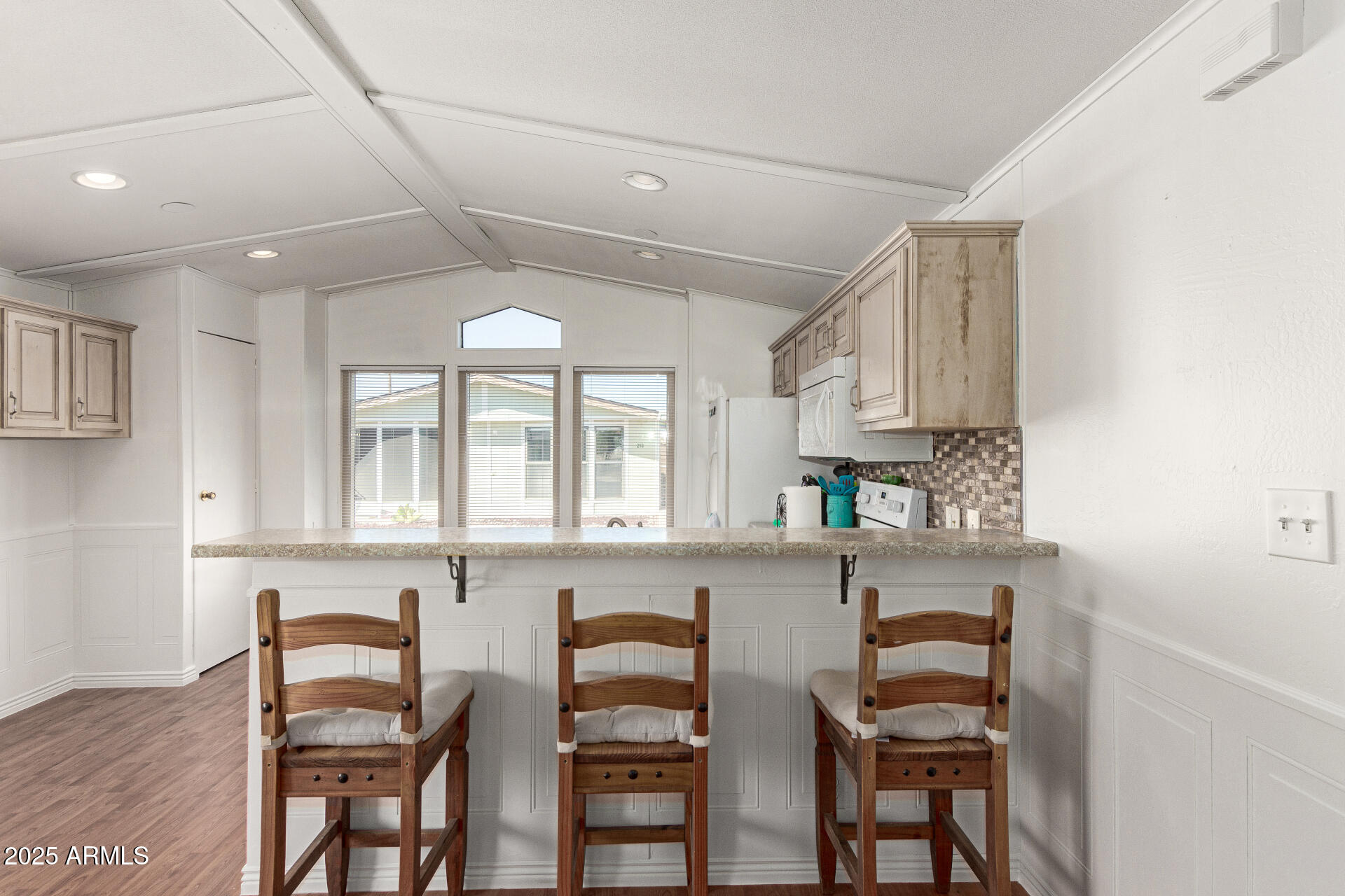 5735 East McDowell Road, Unit 213 Mesa, AZ 85215 - Photo 7 of 18 a kitchen with stainless steel appliances granite countertop a table chairs sink and cabinets
