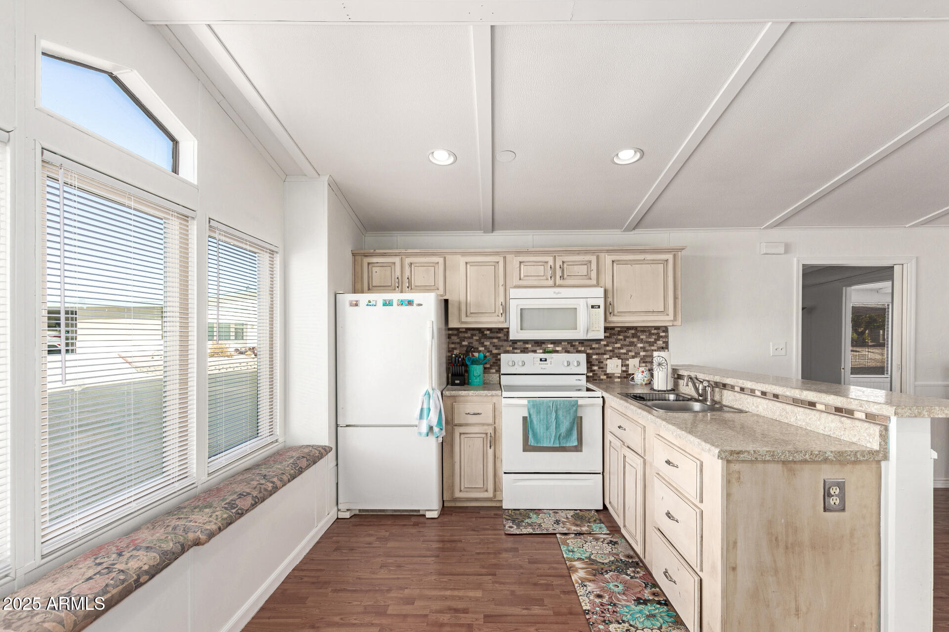 5735 East McDowell Road, Unit 213 Mesa, AZ 85215 - Photo 9 of 18 a kitchen with stainless steel appliances granite countertop a refrigerator a oven a sink dishwasher and white cabinets with wooden floor