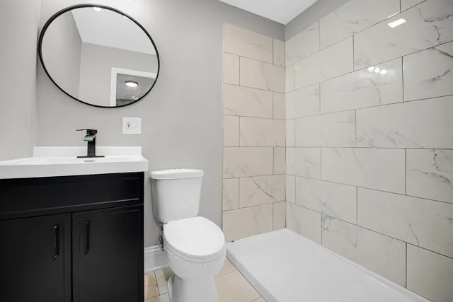 a bathroom with a sink a toilet and a mirror