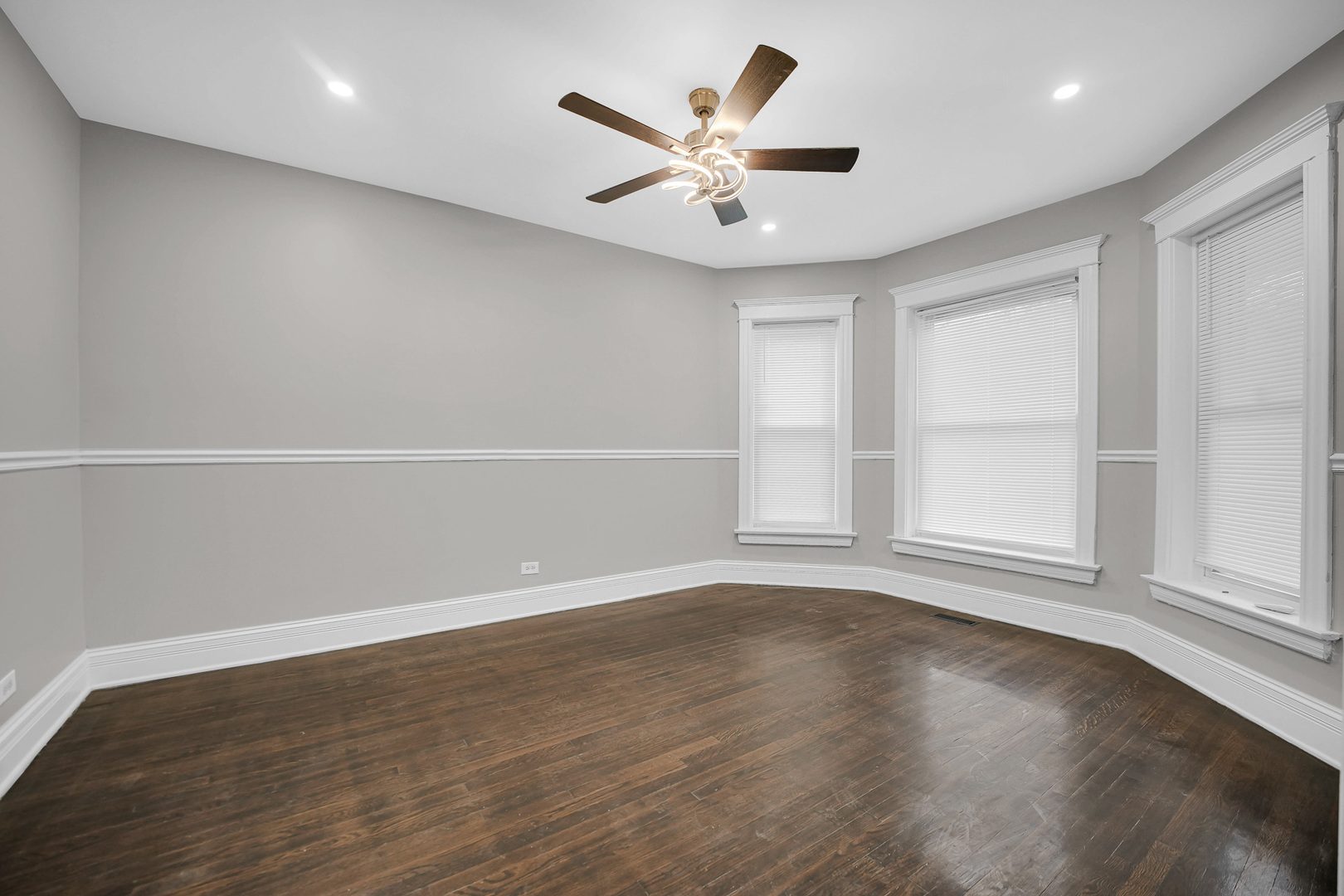 7621 South Normal Avenue Chicago, IL 60620 - Photo 15 of 32 an empty room with wooden floor and windows