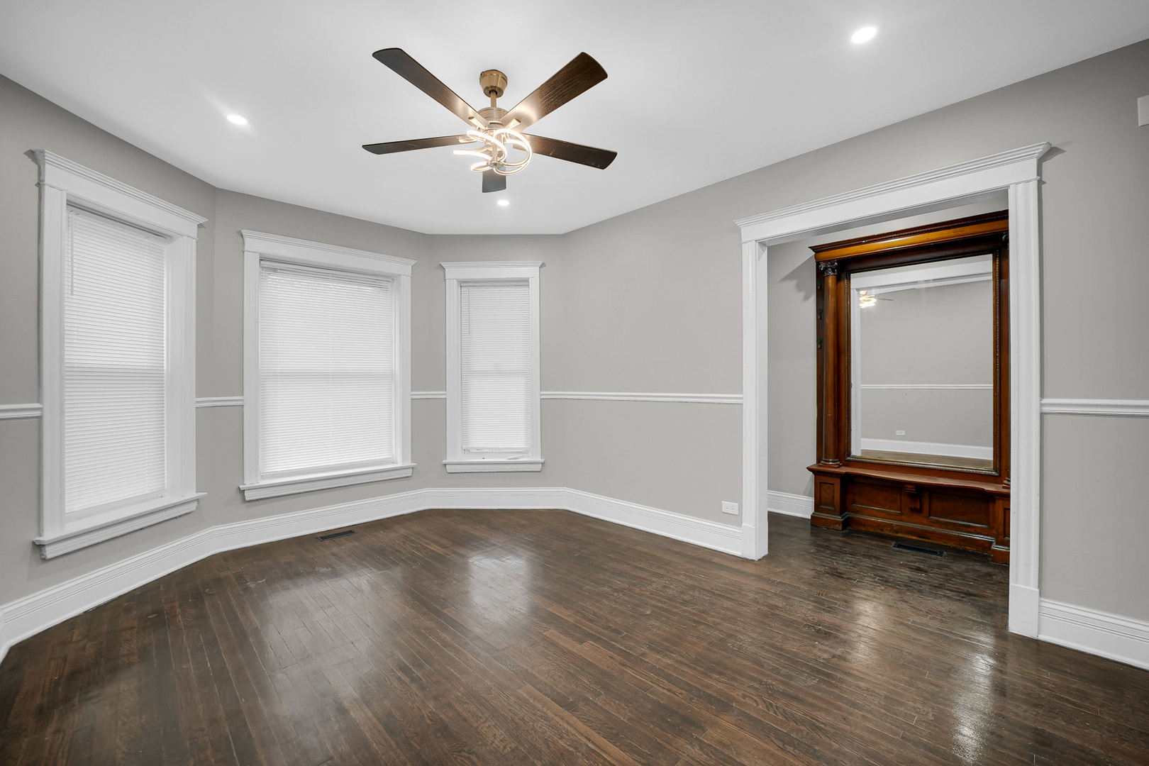 7621 South Normal Avenue Chicago, IL 60620 - Photo 16 of 32 an empty room with wooden floor and windows
