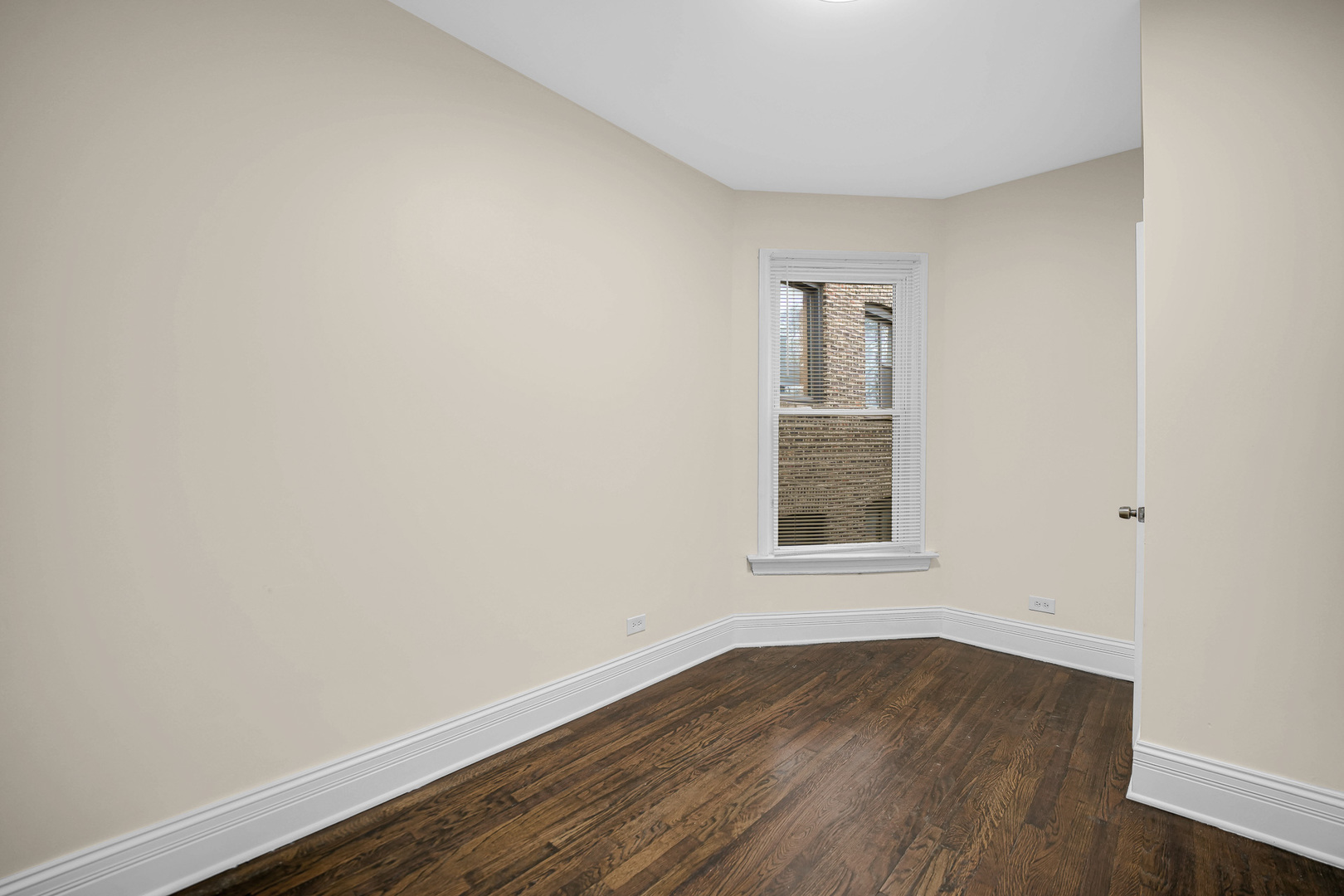 7621 South Normal Avenue Chicago, IL 60620 - Photo 20 of 32 an empty room with wooden floor and windows