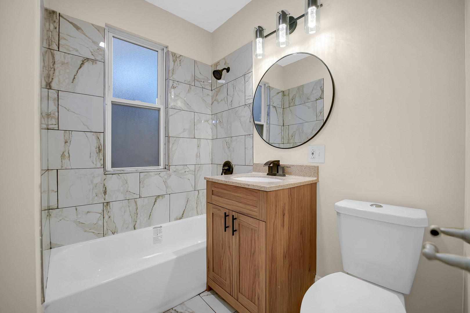 7621 South Normal Avenue Chicago, IL 60620 - Photo 22 of 32 a bathroom with a sink a toilet and a bathtub