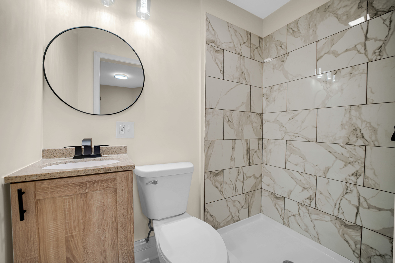 7621 South Normal Avenue Chicago, IL 60620 - Photo 24 of 32 a bathroom with a toilet sink vanity and mirror