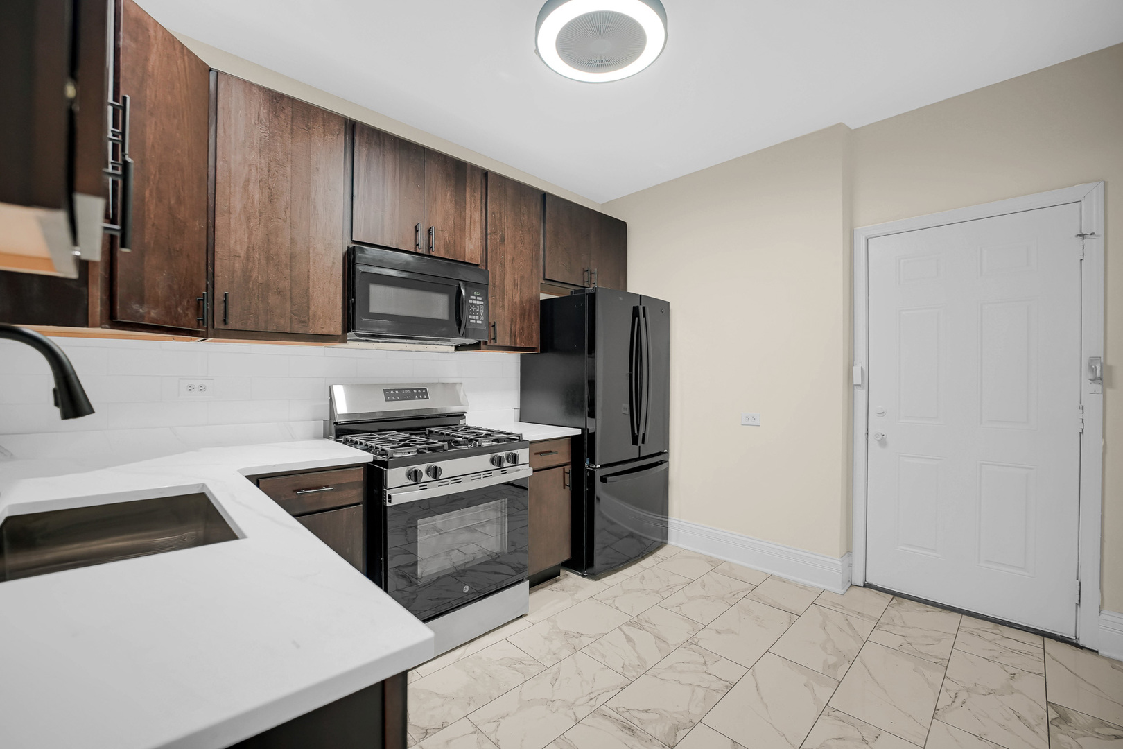 7621 South Normal Avenue Chicago, IL 60620 - Photo 25 of 32 a kitchen with stainless steel appliances granite countertop a sink stove and refrigerator