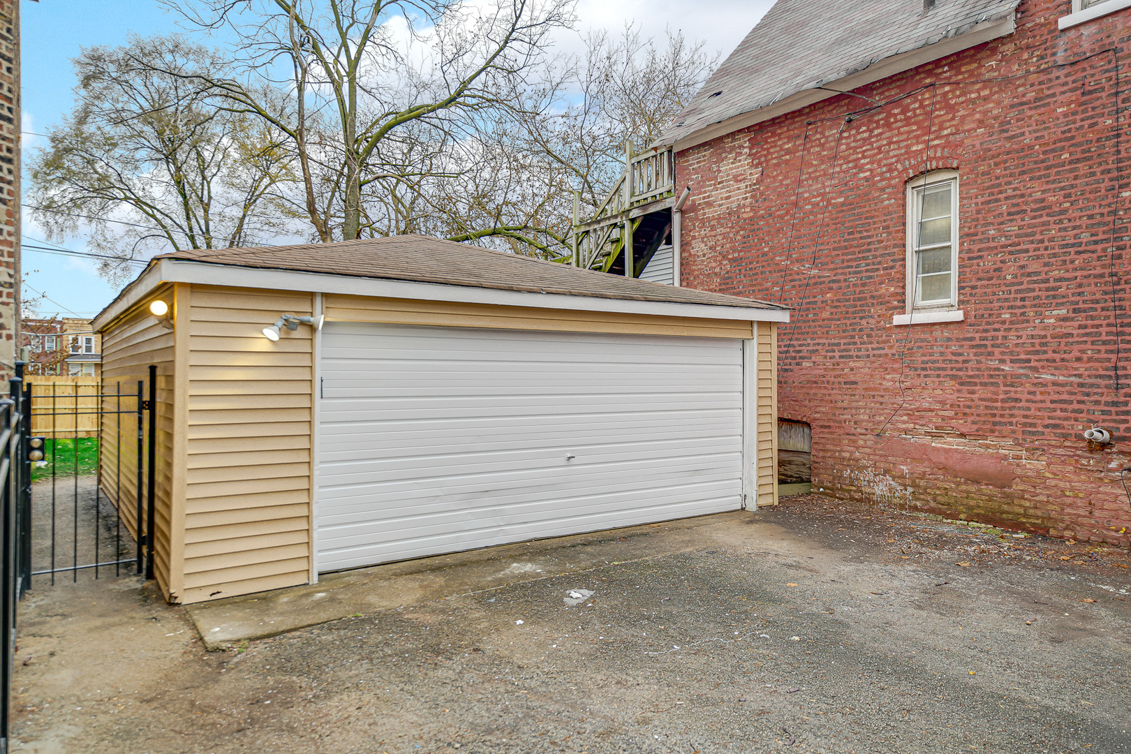 7621 South Normal Avenue Chicago, IL 60620 - Photo 4 of 32 a view of a house with a yard and garage