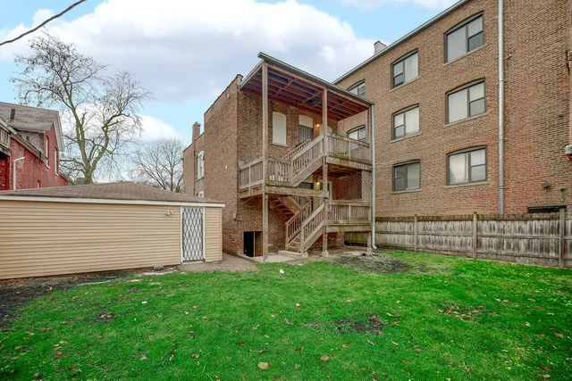 a view of a house with a yard and sitting area