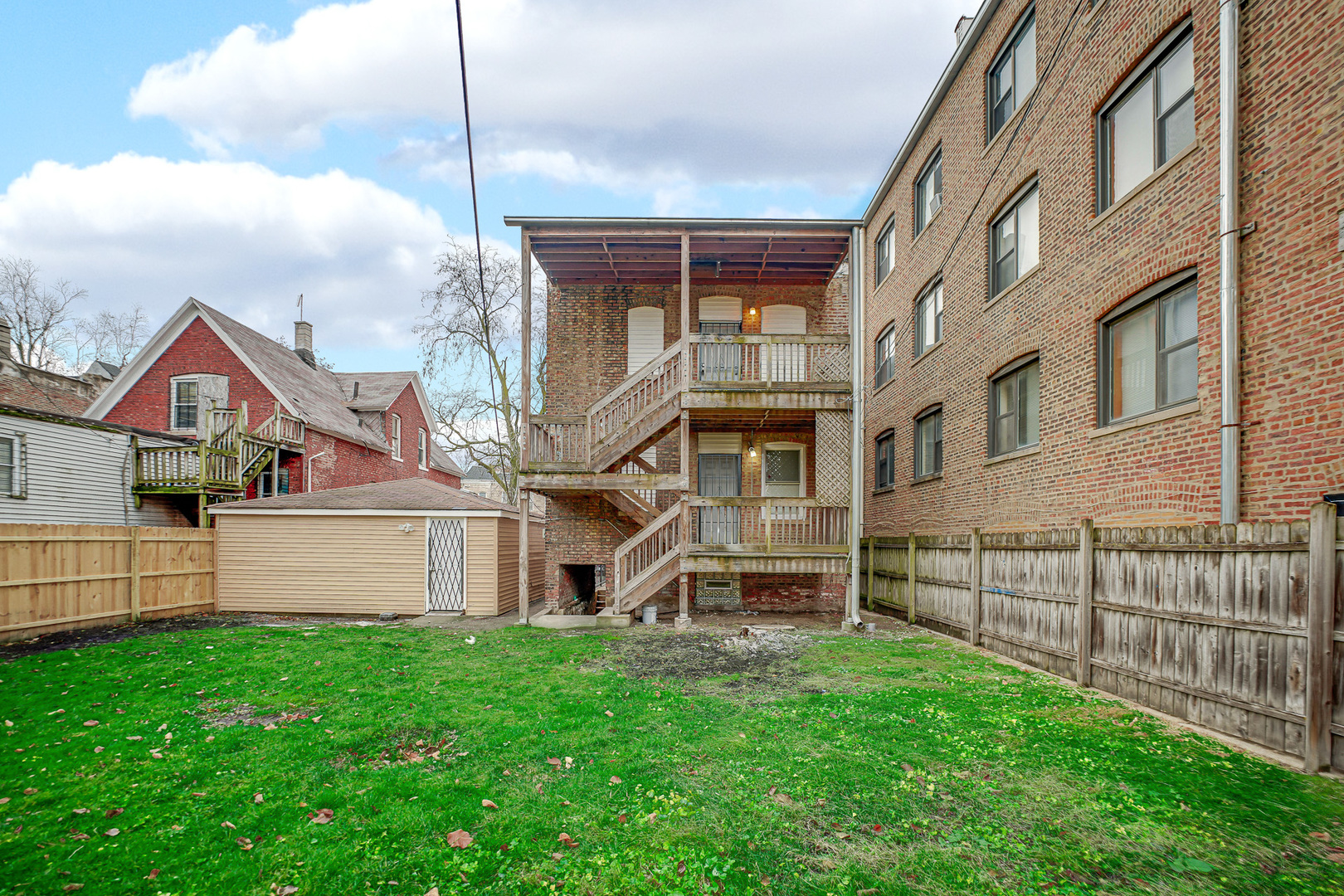 7621 South Normal Avenue Chicago, IL 60620 - Photo 7 of 32 a view of a house with a large window and a fence