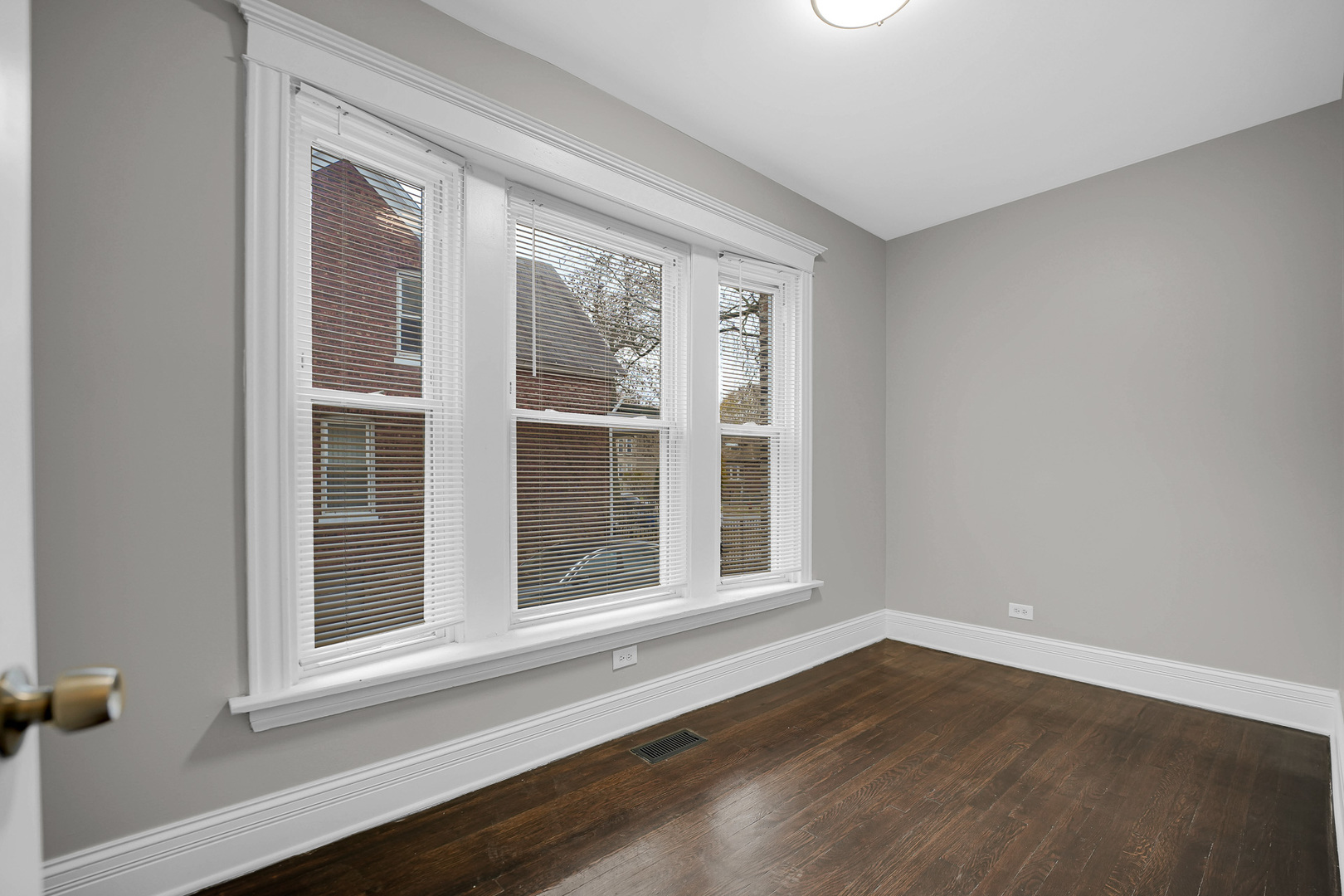 7621 South Normal Avenue Chicago, IL 60620 - Photo 8 of 32 a view of an empty room with wooden floor and a window