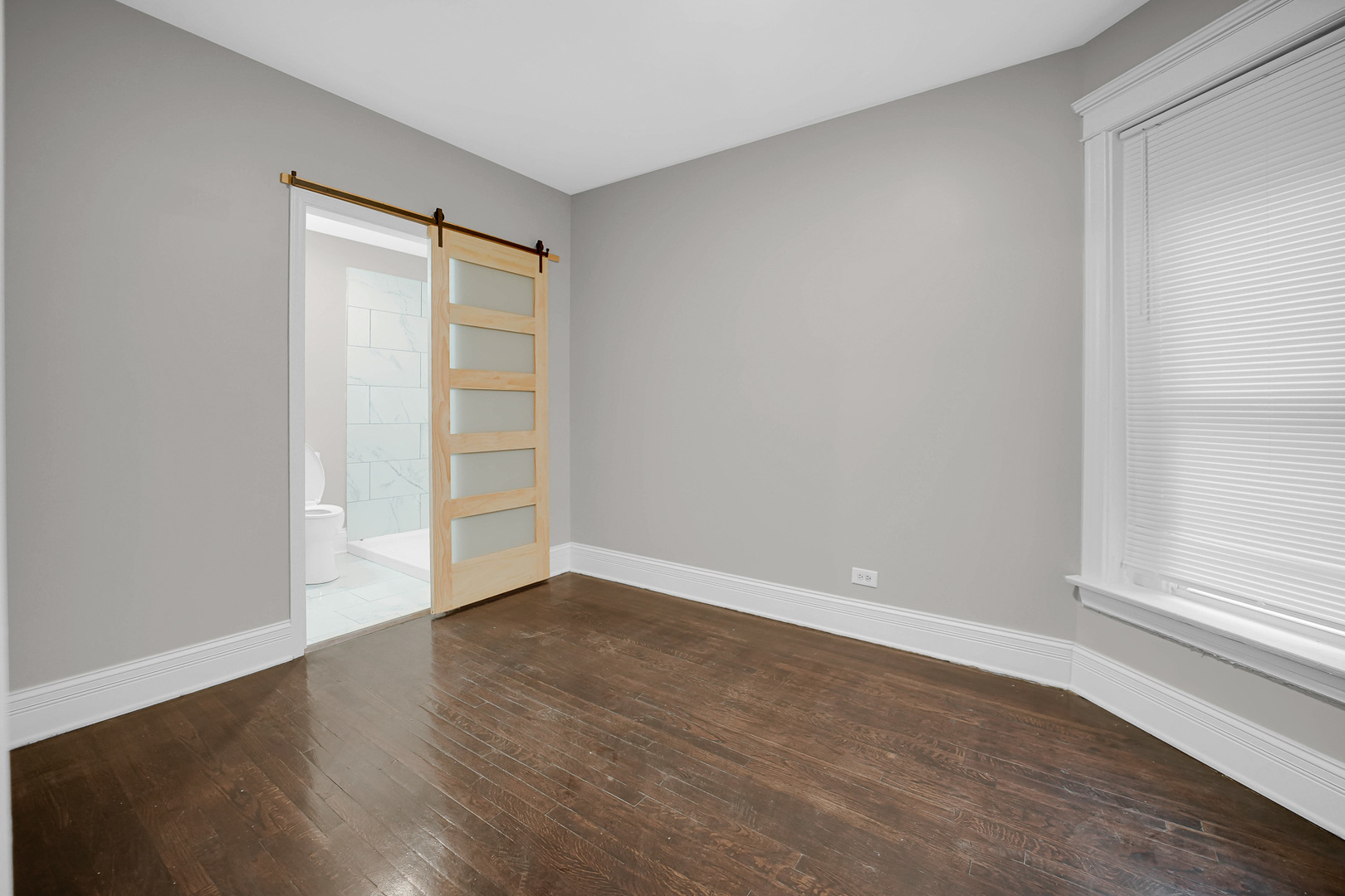 7621 South Normal Avenue Chicago, IL 60620 - Photo 10 of 32 a view of an empty room with wooden floor and a window