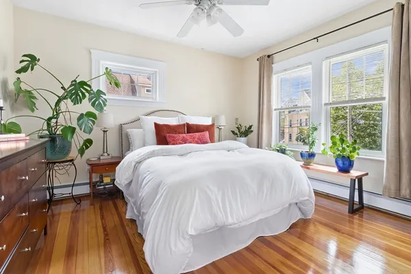 a bed sitting in a bedroom next to a window