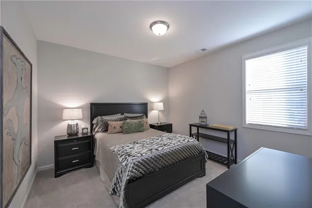 a bedroom with a bed and a night stand