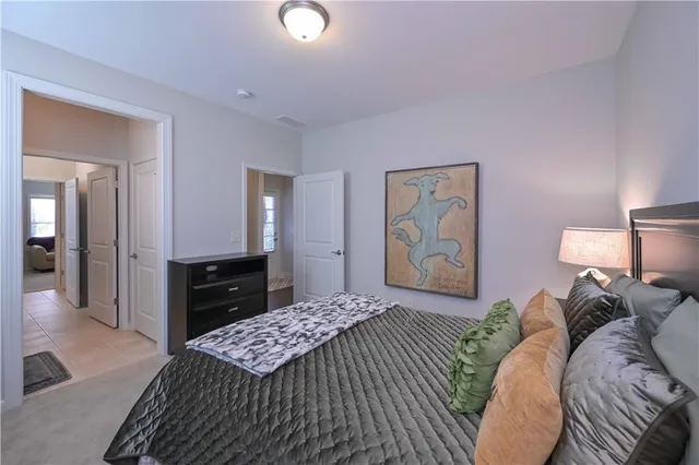 a bedroom with a bed and painting on the wall