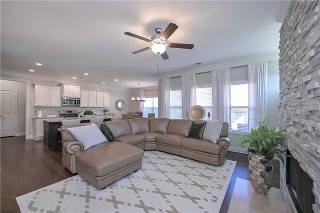 a living room with furniture and kitchen view