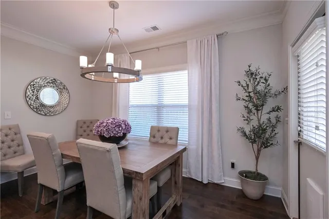 a dining room with furniture a chandelier and window