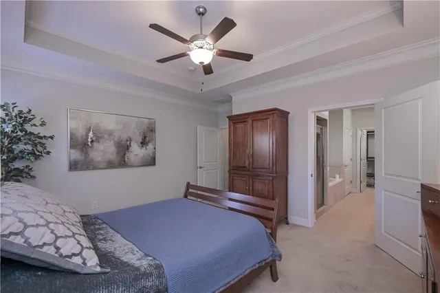 a bedroom with a large bed and a chandelier