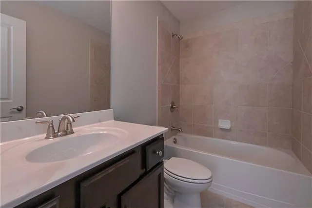 a bathroom with a sink a toilet and a bathtub