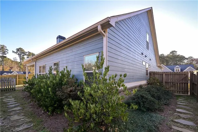 a view of a house with a yard and plants