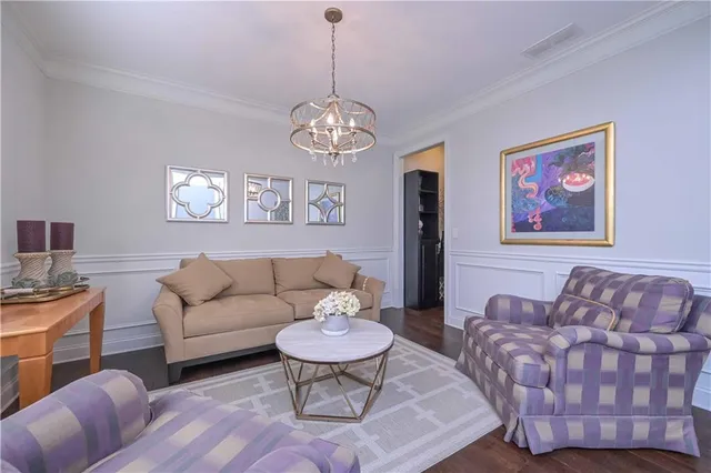 a living room with furniture chandelier and a couch