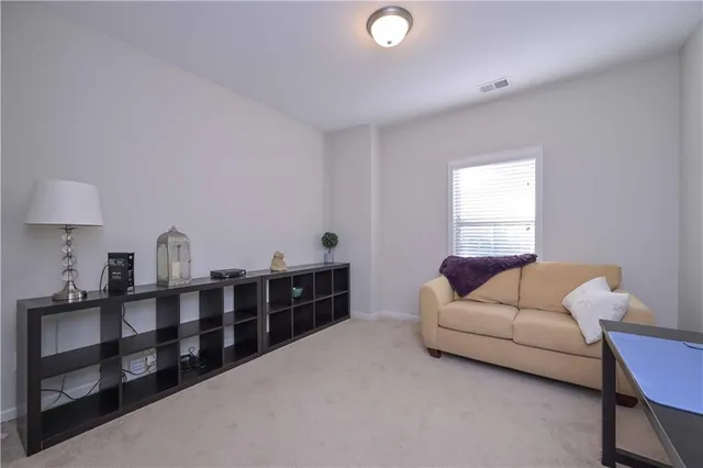 a living room with furniture a window and a lamp