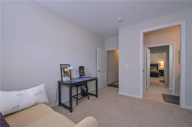 a view of a workspace with furniture and a bathroom
