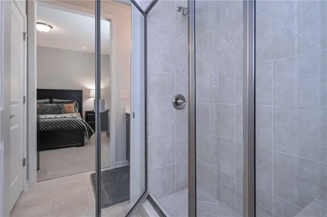 a en suite bathroom with a shower and a sink