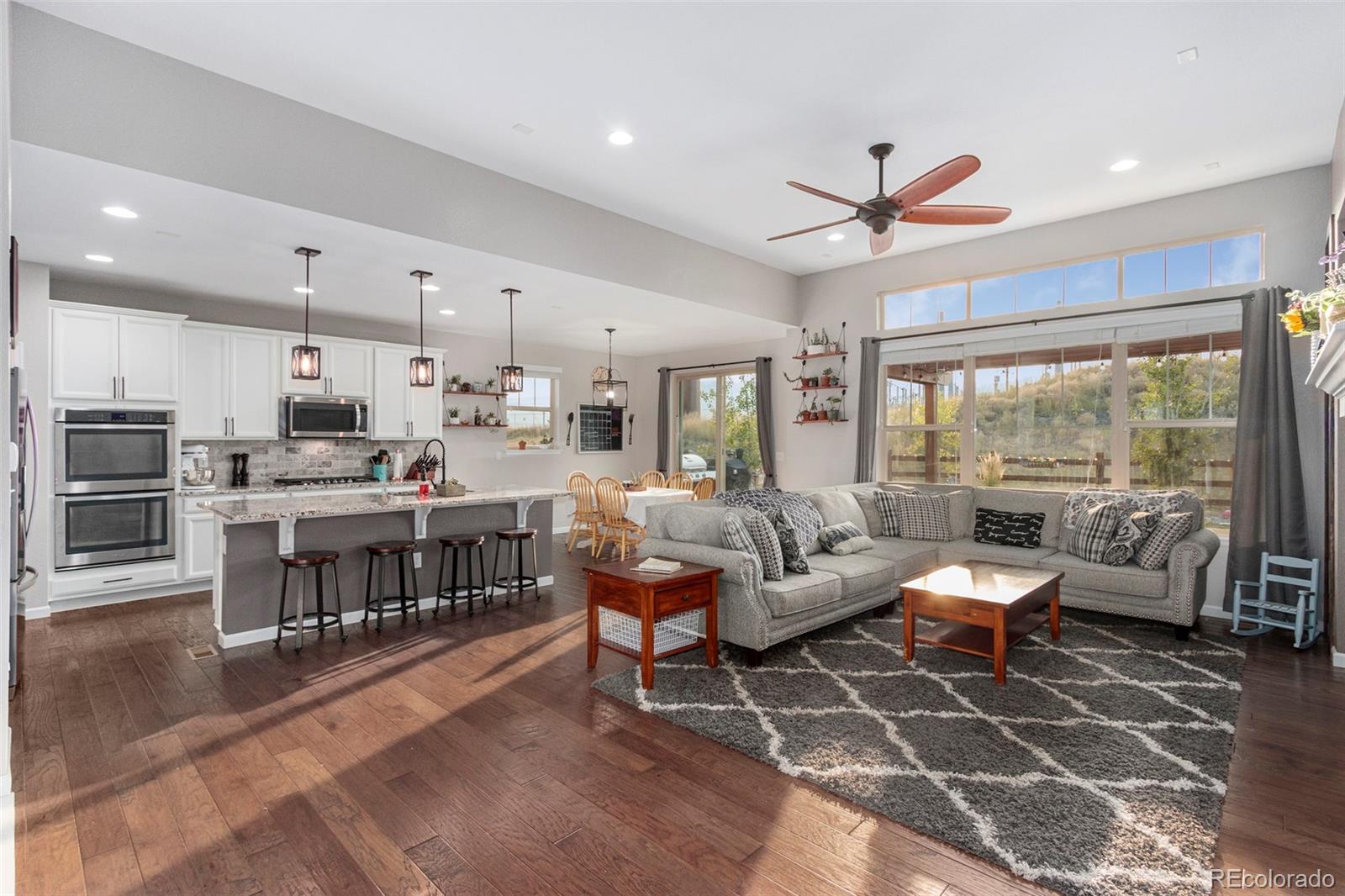 8875 Flattop Way Arvada, CO 80007 - Photo 1 of 38 a living room with lots of furniture and kitchen view