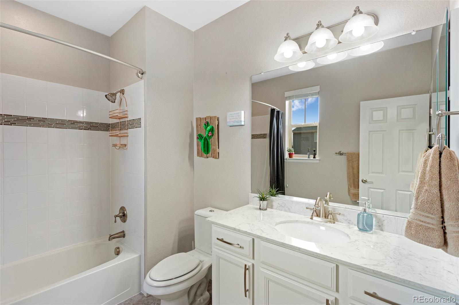 8875 Flattop Way Arvada, CO 80007 - Photo 15 of 38 a bathroom with a sink vanity granite toilet tub and shower
