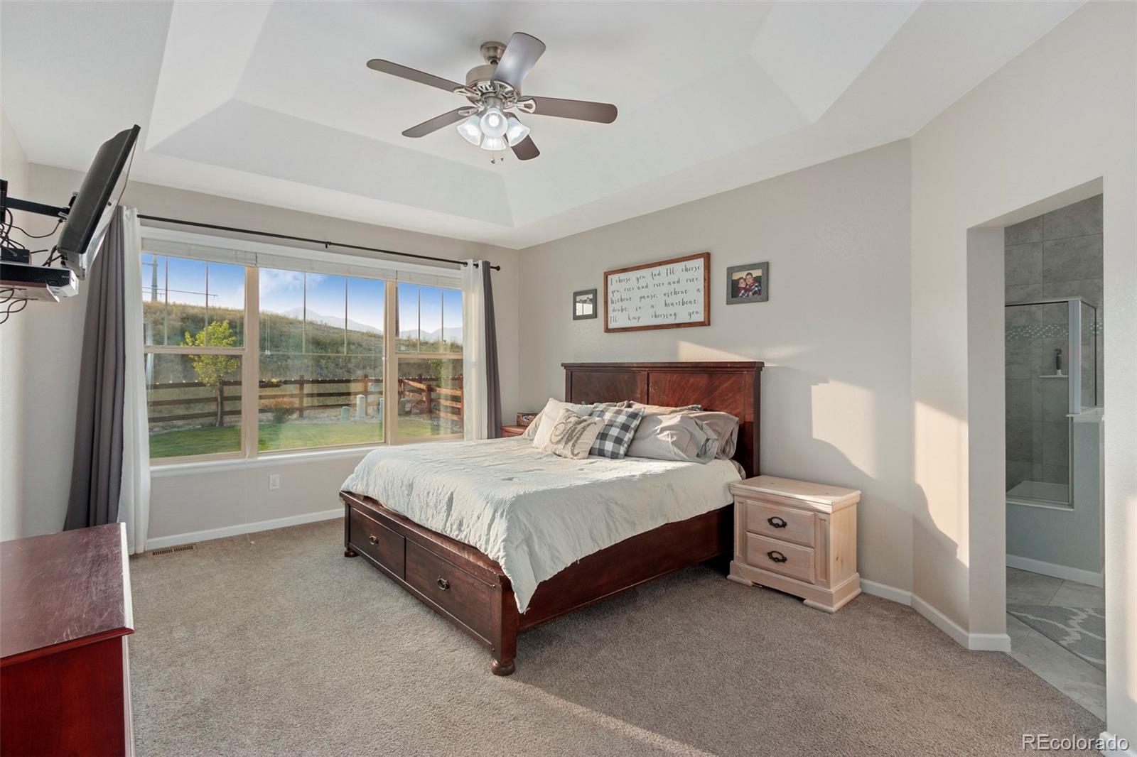 8875 Flattop Way Arvada, CO 80007 - Photo 17 of 38 a bed sitting in a spacious bedroom next to a window
