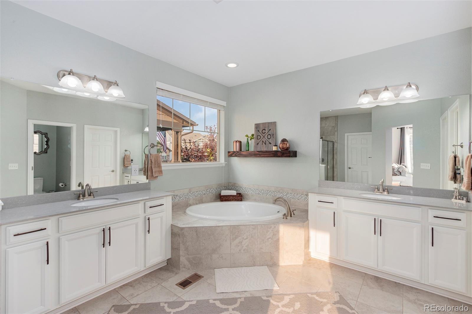 8875 Flattop Way Arvada, CO 80007 - Photo 20 of 38 a bathroom with a toilet sink and mirror