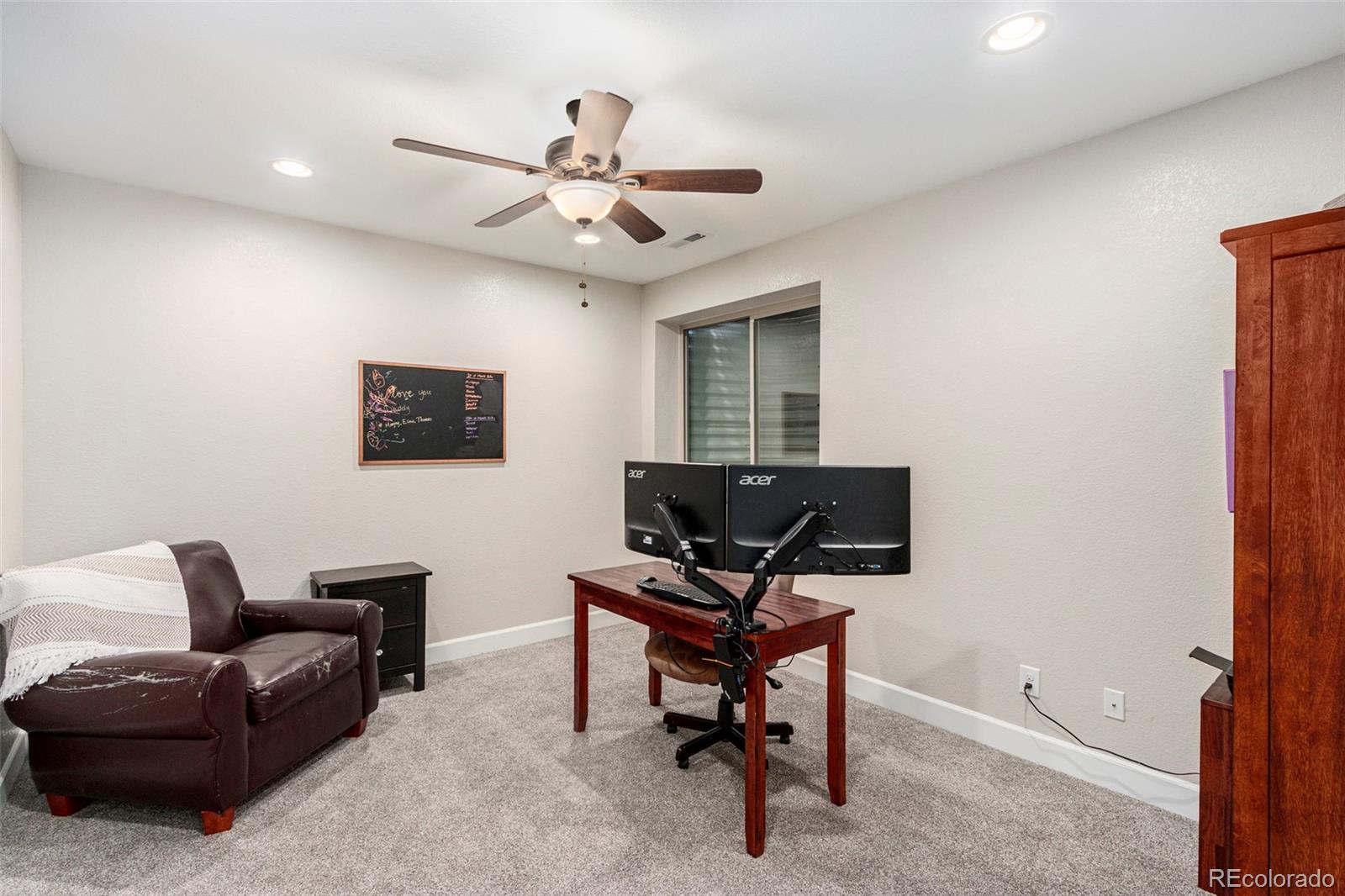 8875 Flattop Way Arvada, CO 80007 - Photo 22 of 38 a view of a livingroom with workspace and a couch